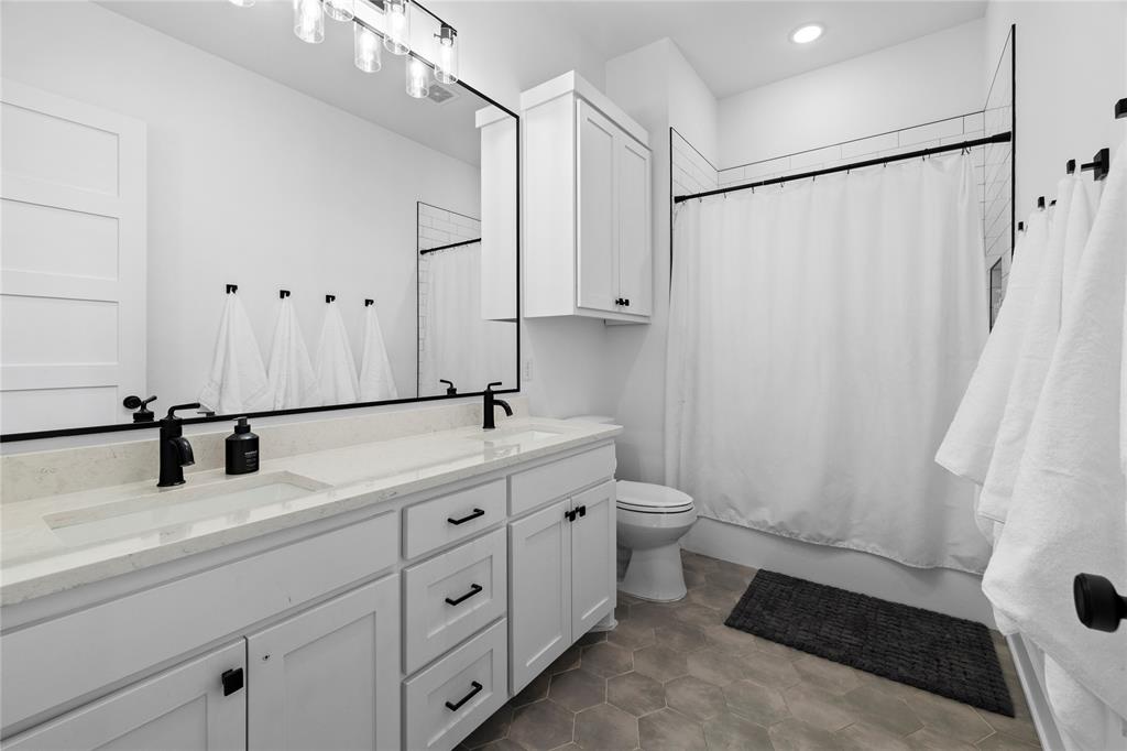 21197 Gatlinburg Road Bullard, TX 75757 - Photo 27 of 40 a bathroom with a double vanity sink and mirror