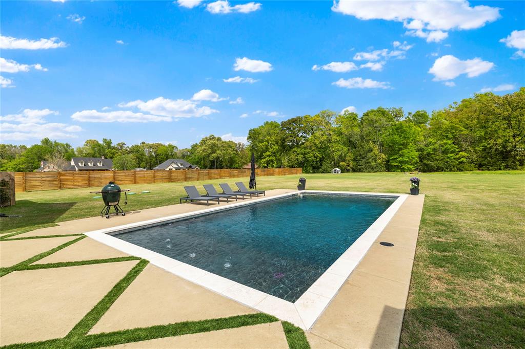 21197 Gatlinburg Road Bullard, TX 75757 - Photo 34 of 40 a view of a swimming pool with an outdoor seating and a yard