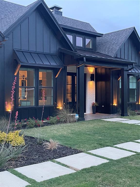 21197 Gatlinburg Road Bullard, TX 75757 - Photo 5 of 40 a view of a house that has a large window and a yard with plants and large trees