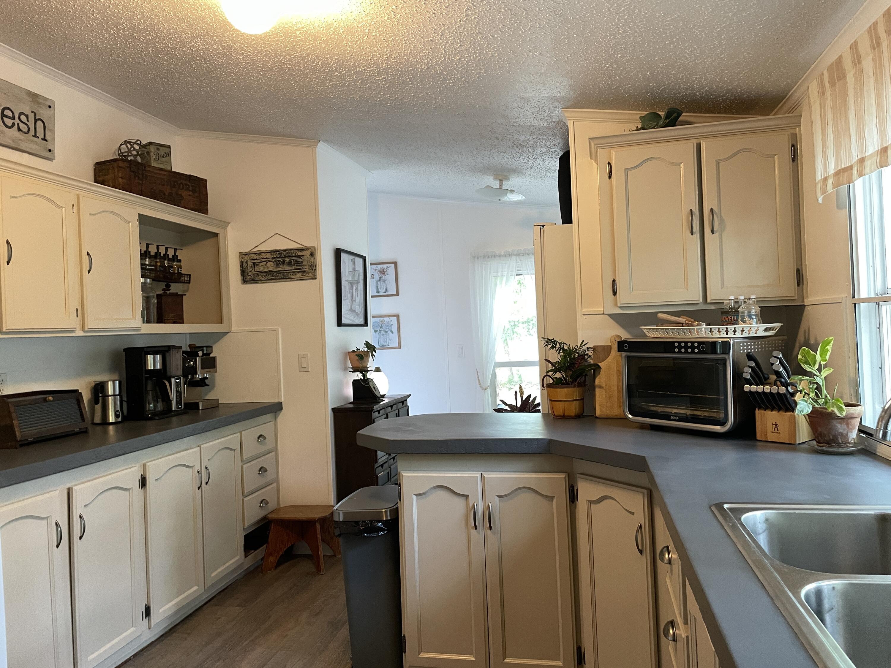 2166 Healing Springs Road Blackville, SC 29817 - Photo 11 of 43 a kitchen with stainless steel appliances a sink stove and cabinets