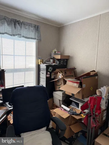 a living room with furniture a piano and a window