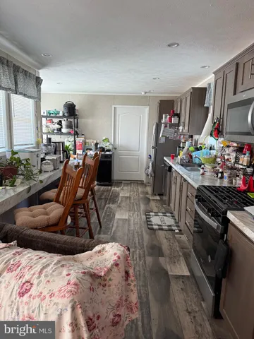 a bedroom with a bed a couch and a flat tv screen