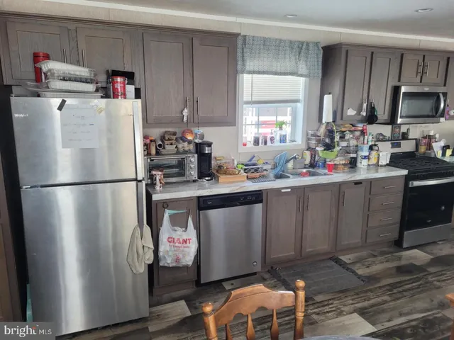 a kitchen with stainless steel appliances a refrigerator sink and cabinets