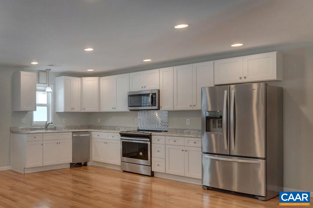 759 Mt Torrey Road Lyndhurst, VA 22952 - Photo 20 of 47 a kitchen with cabinets stainless steel appliances and wooden floor