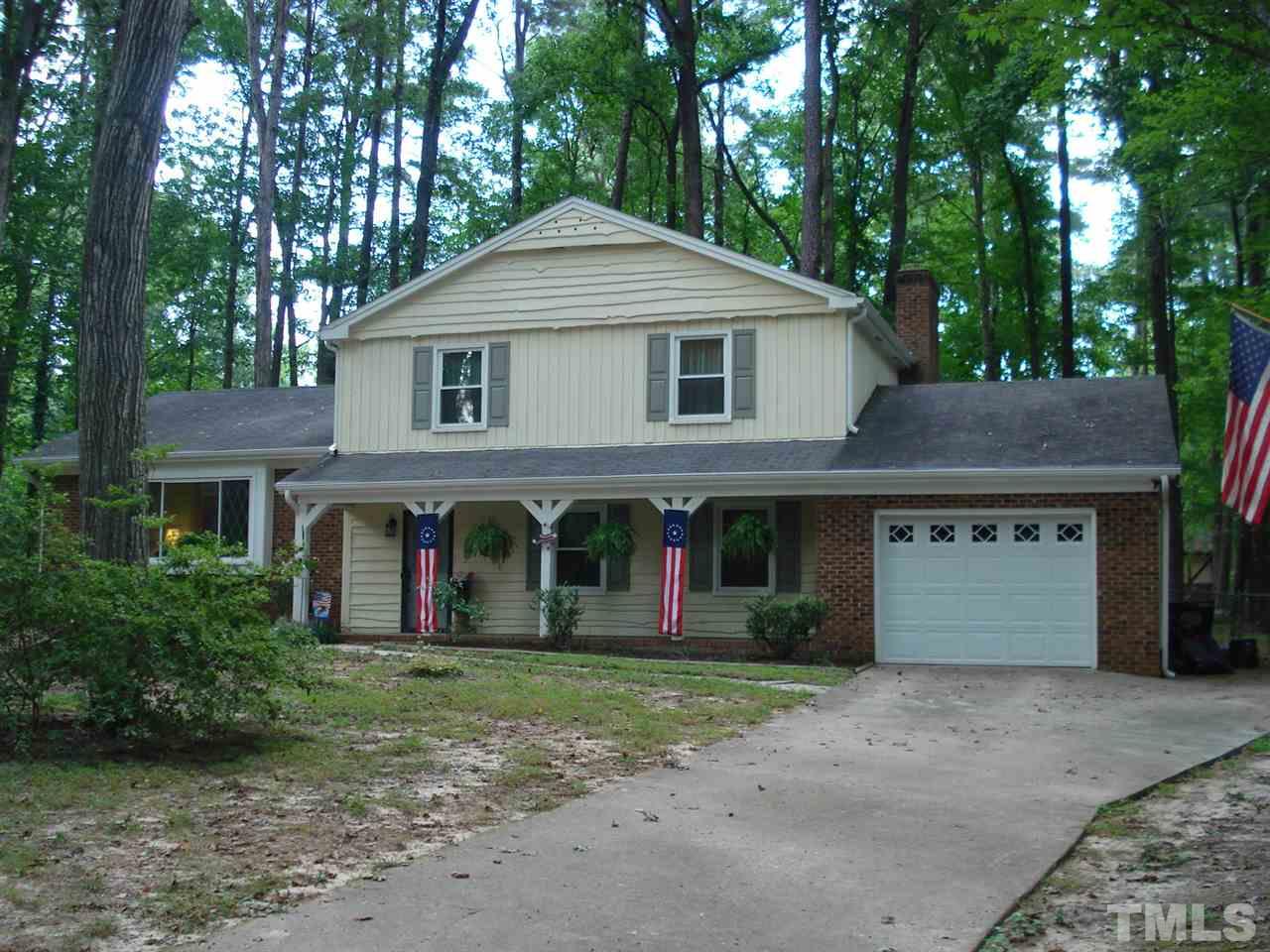 8712 Hidden View Court Raleigh, NC 27613 - Photo 1 of 17 a front view of a house with a yard and garage