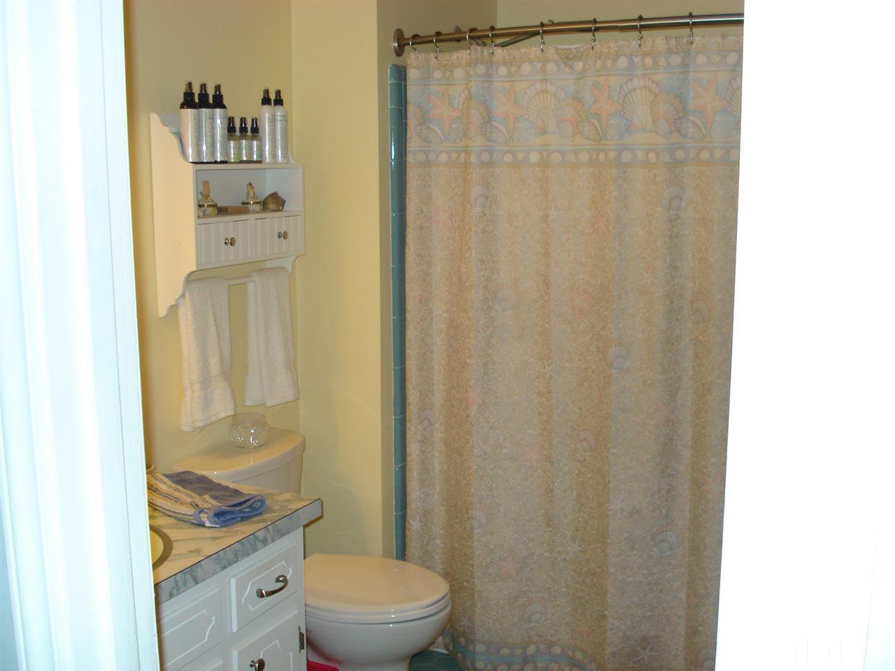 8712 Hidden View Court Raleigh, NC 27613 - Photo 12 of 17 a bathroom with a granite countertop sink mirror and a toilet