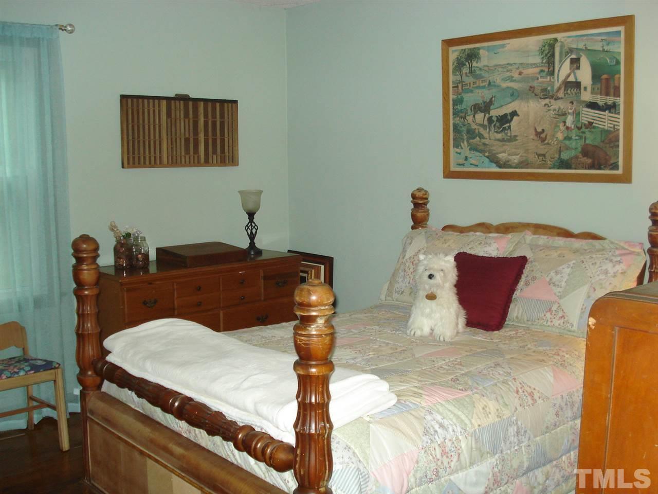 8712 Hidden View Court Raleigh, NC 27613 - Photo 13 of 17 a bedroom with a bed and furniture