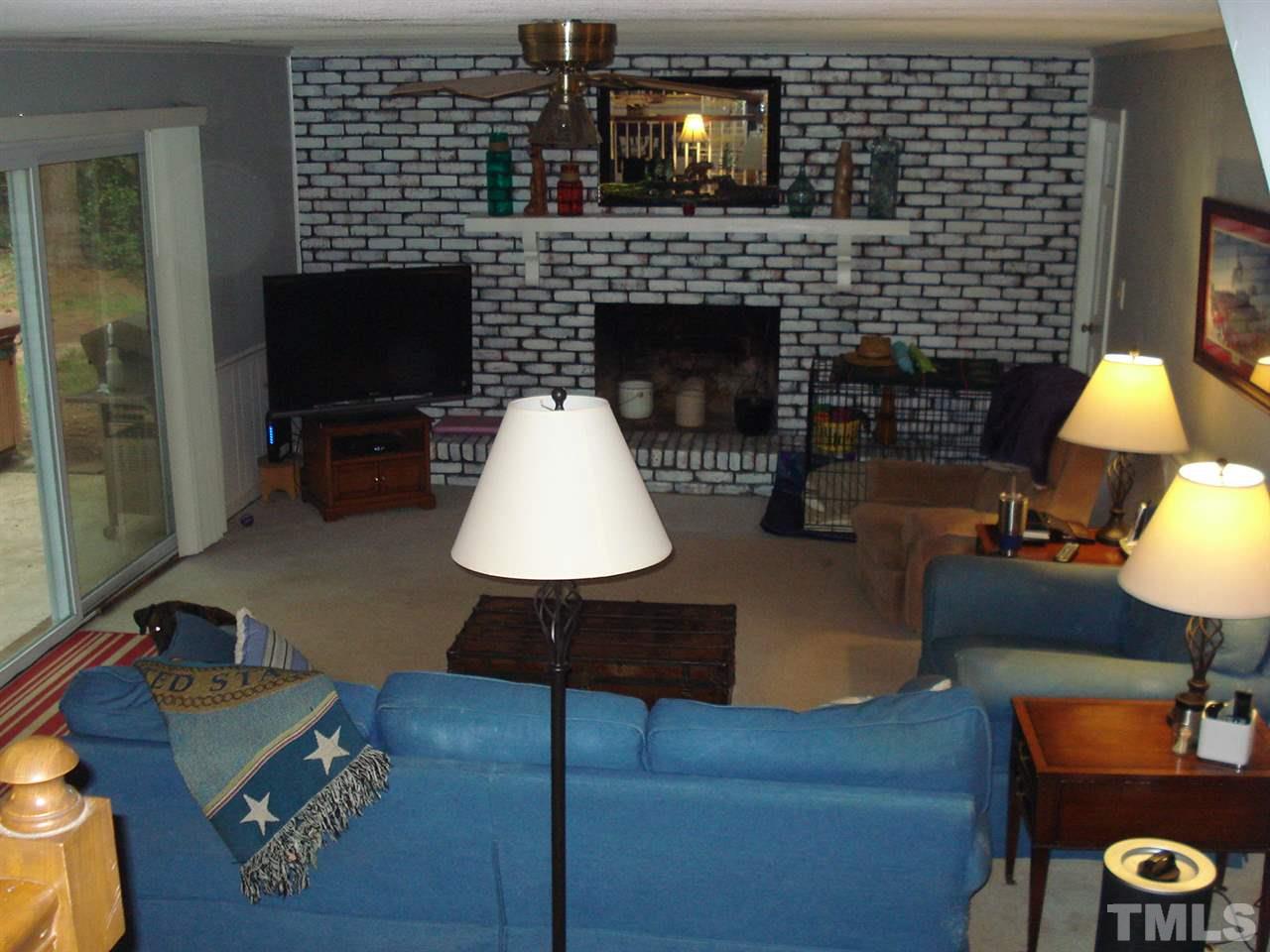 8712 Hidden View Court Raleigh, NC 27613 - Photo 9 of 17 a living room with furniture a flat screen tv and a fireplace