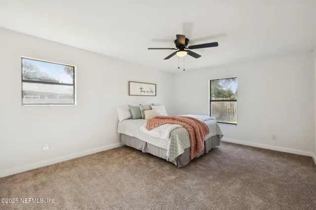a bathroom with a double vanity sink toilet mirror and shower