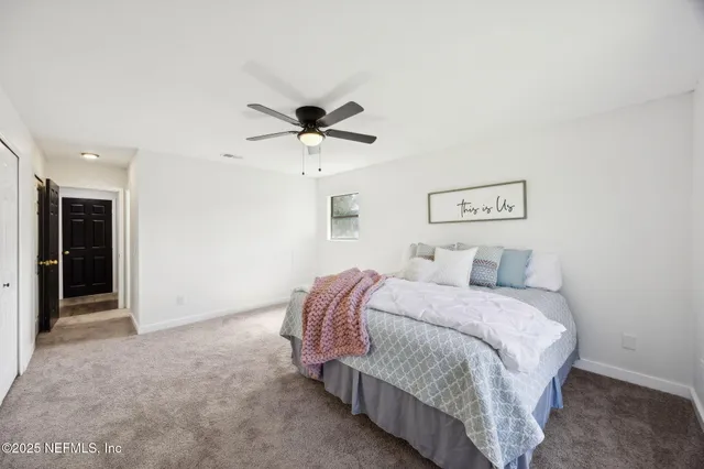 a bedroom with a bed and window