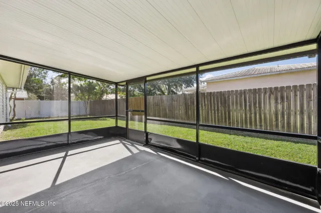 a front view of a door with plants and trees