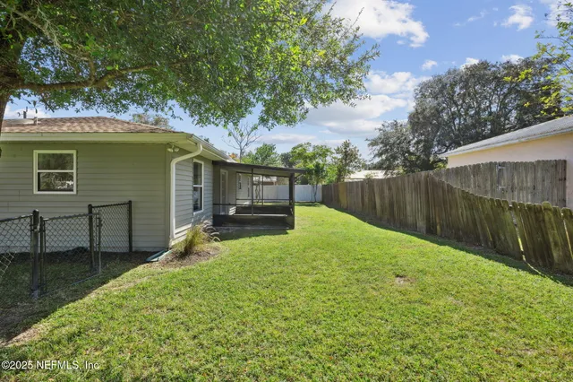 an aerial view of a house with swimming pool garden and trees
