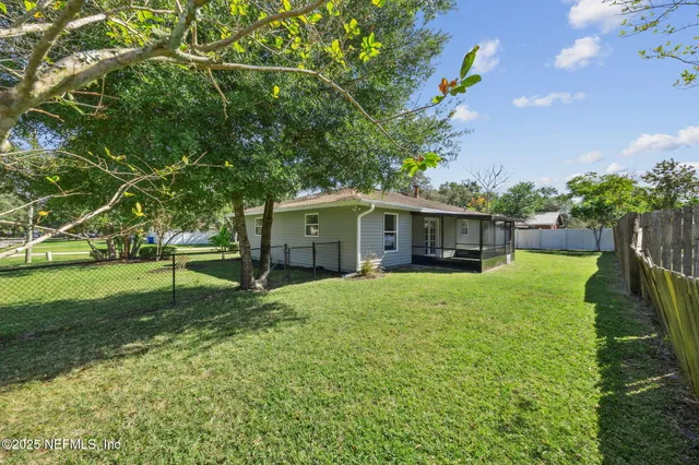 a backyard of a house with barbeque oven table and chairs