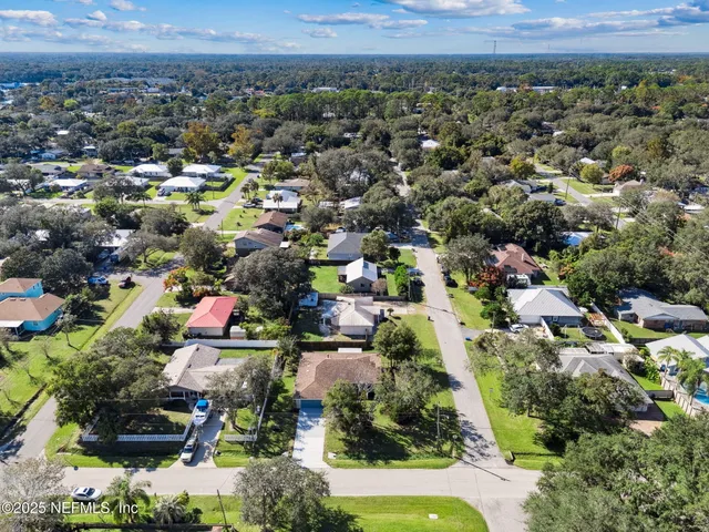 an aerial view of a house with a ocean view
