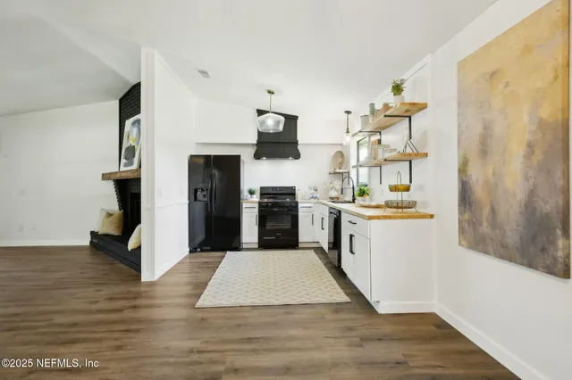 a view of a kitchen with a sink and a stove top oven