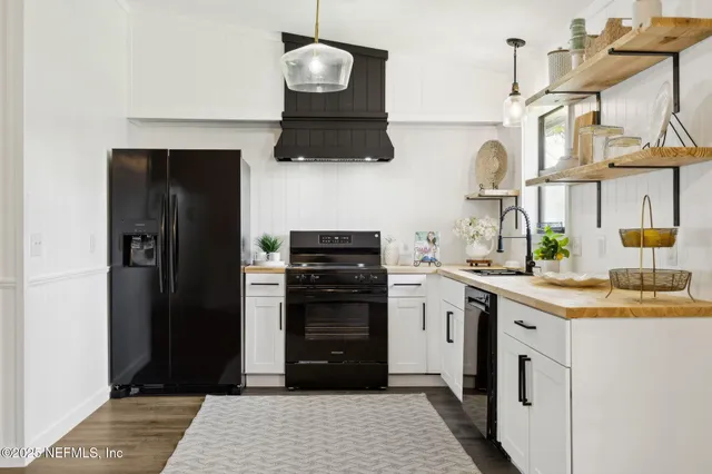 a kitchen with stainless steel appliances kitchen island granite countertop a sink a stove and a refrigerator