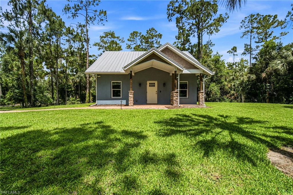 2053 17th Street Southwest Naples, FL 34117 - Photo 26 of 47 a front view of house with yard and green space