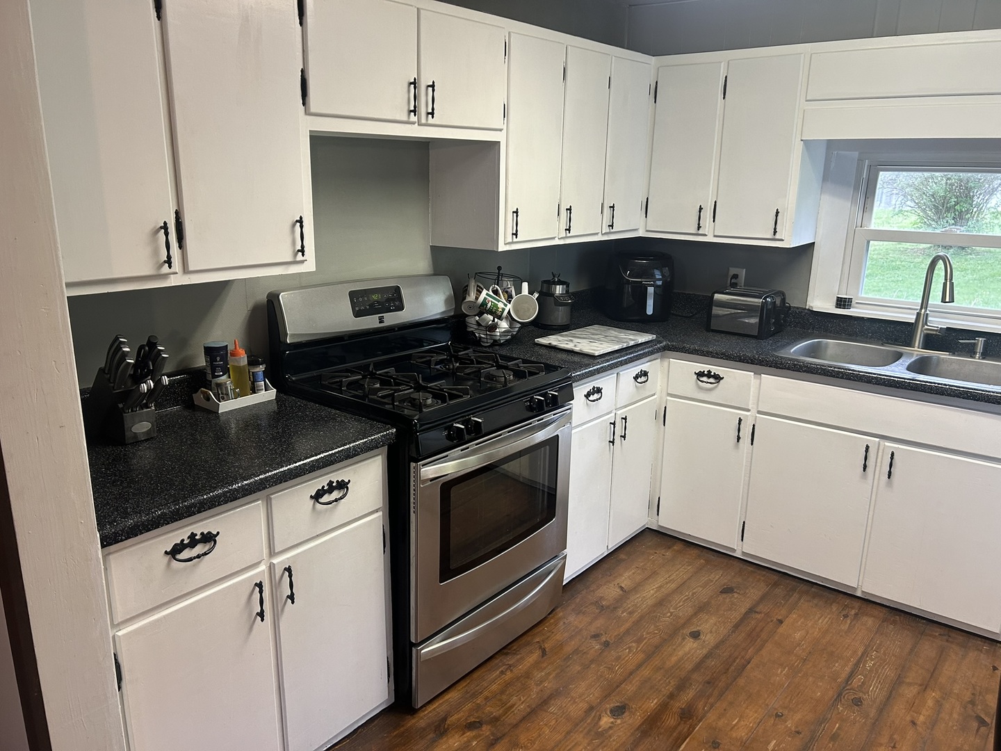 1 Bushwack Road Golconda, IL 62938 - Photo 21 of 38 a kitchen with granite countertop white cabinets and white appliances