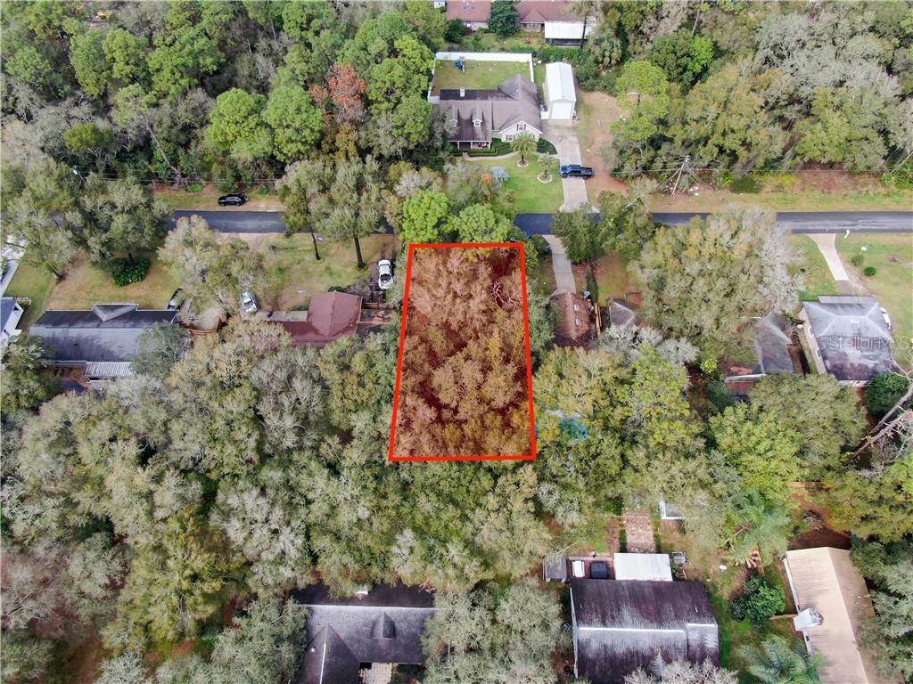 Quaker Ridge Ave Mount Sorrento, FL 32776 - Photo 1 of 1 an aerial view of a house with a yard