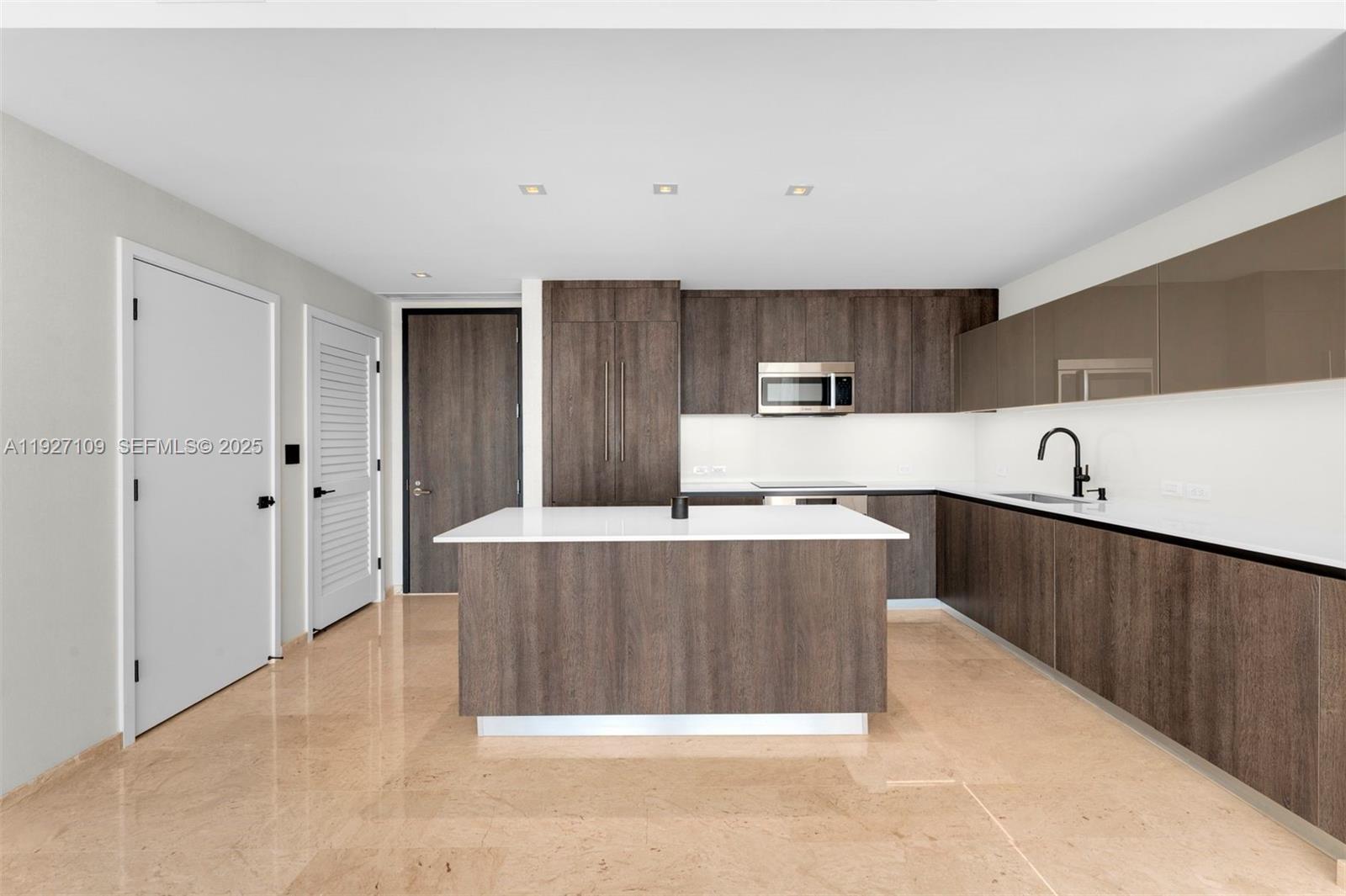 a kitchen with stainless steel appliances a refrigerator and a stove top oven