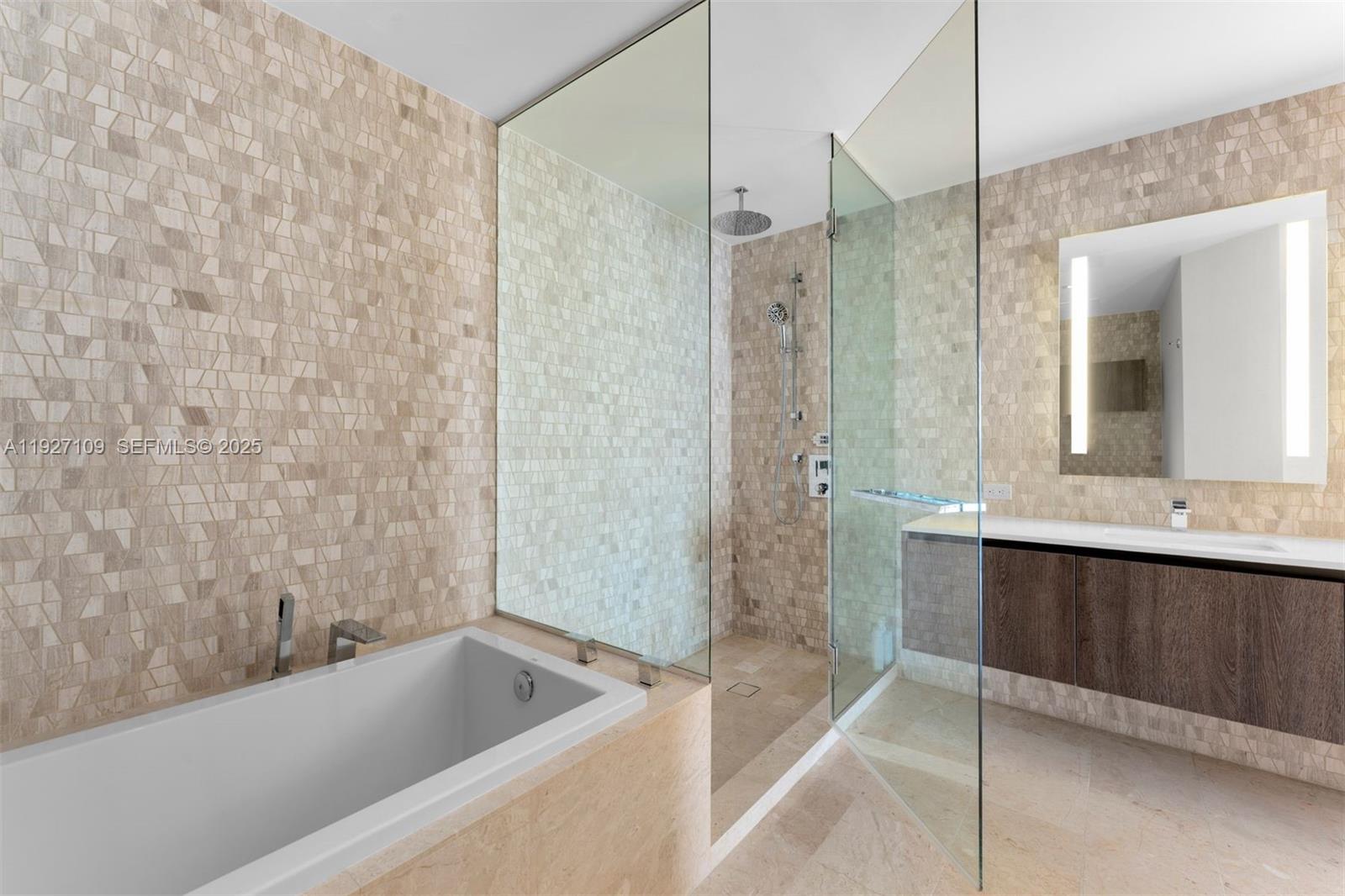 88 Southwest 7th Street, Unit 3907 Miami, FL 33130 - Photo 24 of 33 a bathroom with a bathtub and a sink