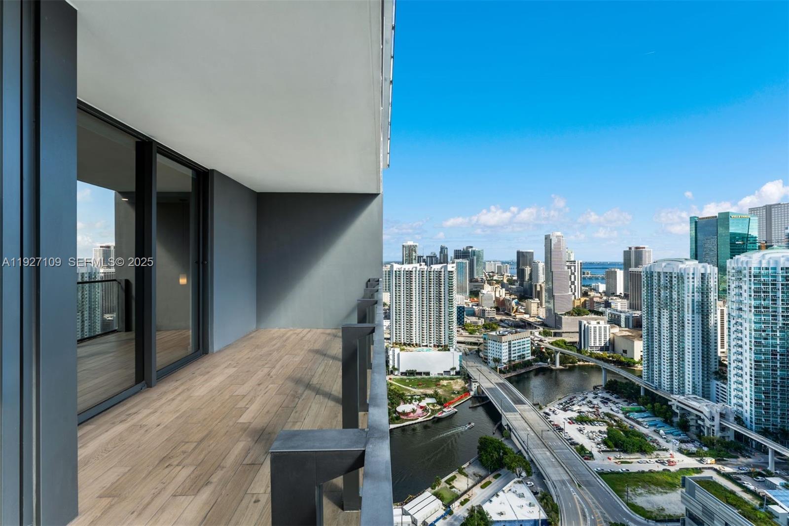 88 Southwest 7th Street, Unit 3907 Miami, FL 33130 - Photo 27 of 33 a view of a balcony with wooden floor