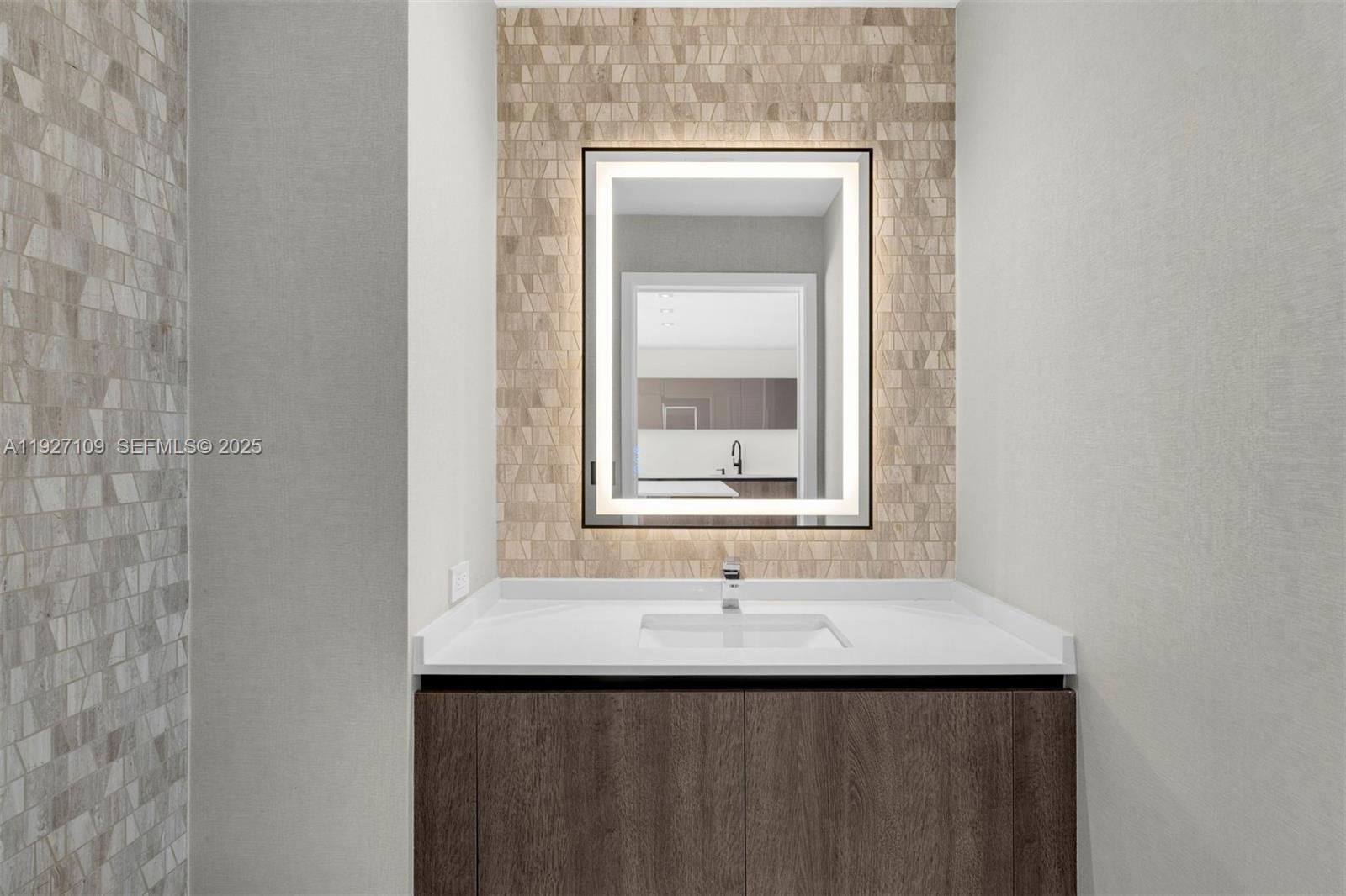 88 Southwest 7th Street, Unit 3907 Miami, FL 33130 - Photo 4 of 33 a bathroom with a sink and a mirror