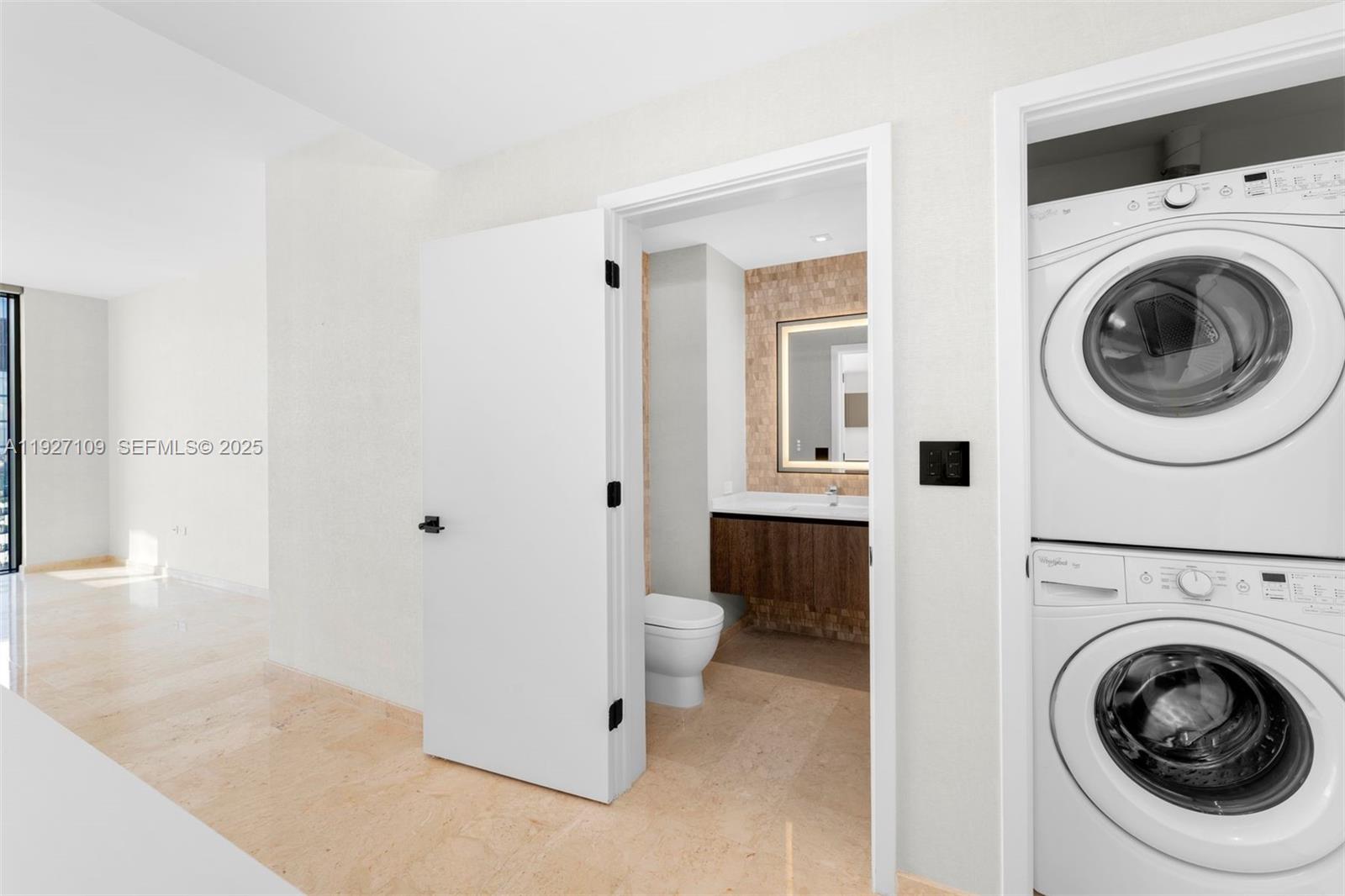 88 Southwest 7th Street, Unit 3907 Miami, FL 33130 - Photo 6 of 33 a view of a hallway with washer and dryer