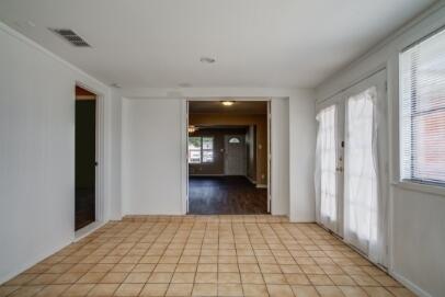 2611 49th Street Lubbock, TX 79413 - Photo 12 of 35 a view of a hallway with wooden floor and a living room