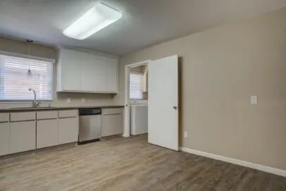 a kitchen with granite countertop white cabinets and white appliances