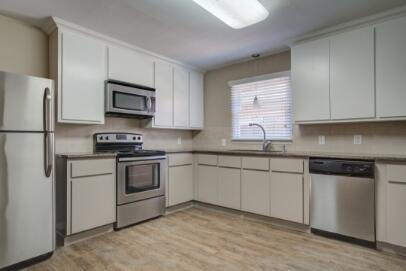 2611 49th Street Lubbock, TX 79413 - Photo 14 of 35 a kitchen with cabinets stainless steel appliances and window