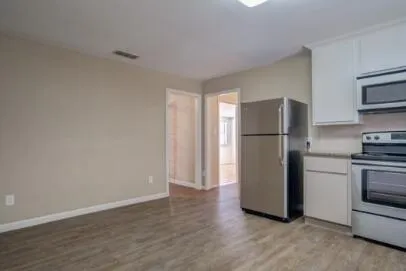 a view of a kitchen with a refrigerator a stove top oven and refrigerator