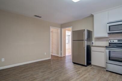 2611 49th Street Lubbock, TX 79413 - Photo 16 of 35 a view of a kitchen with a refrigerator a stove top oven and refrigerator