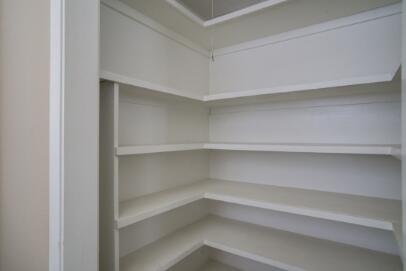 2611 49th Street Lubbock, TX 79413 - Photo 18 of 35 a view of walk in closet with empty racks