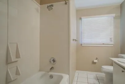 a bathroom with a bathtub and a toilet