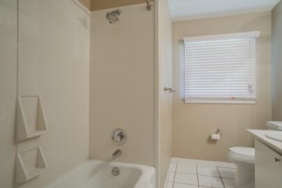 2611 49th Street Lubbock, TX 79413 - Photo 19 of 35 a bathroom with a bathtub and a toilet