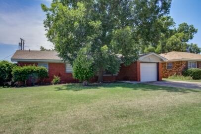 2611 49th Street Lubbock, TX 79413 - Photo 2 of 35 a front view of a house with a yard and garage