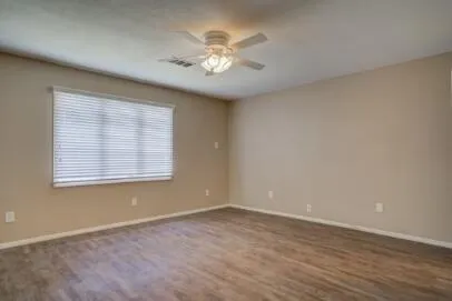 wooden floor in an empty room with a window