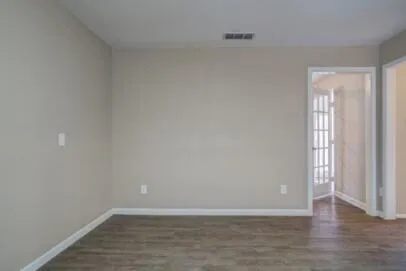 a view of an empty room and wooden floor