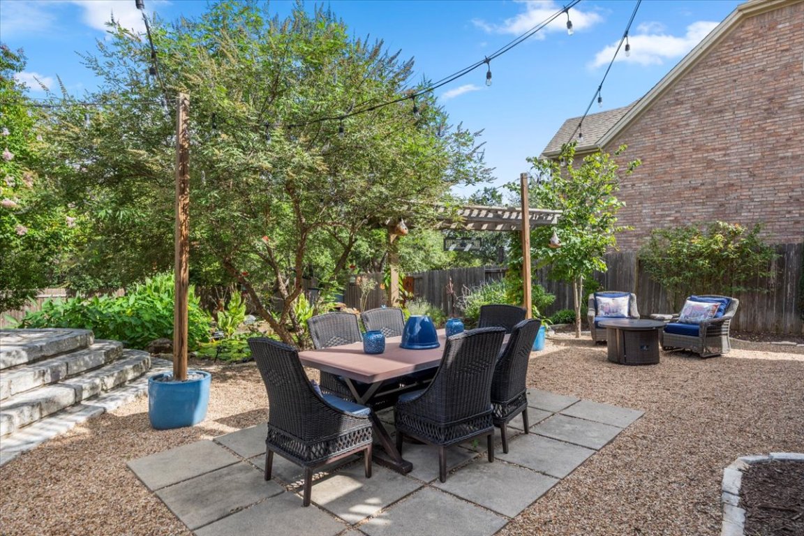 a view of a backyard with sitting area