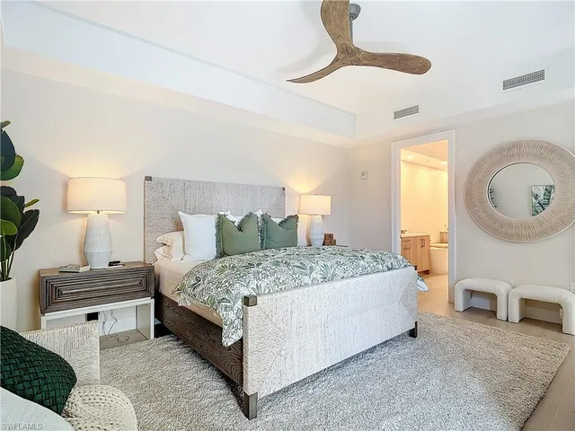 a bedroom with a bed a couch and dresser