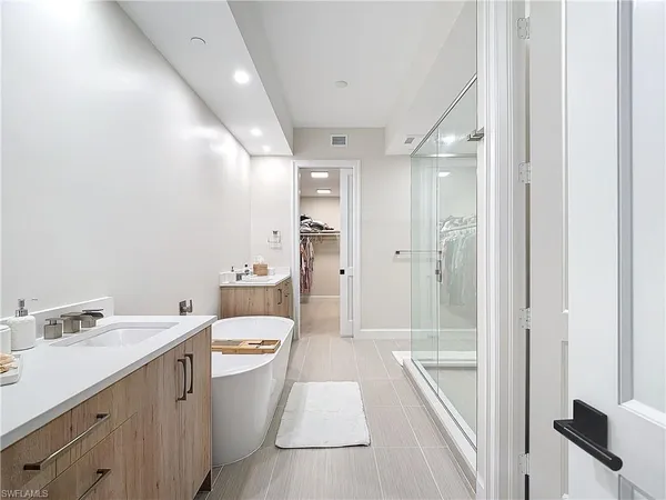 a bathroom with a sink a toilet a tub and shower