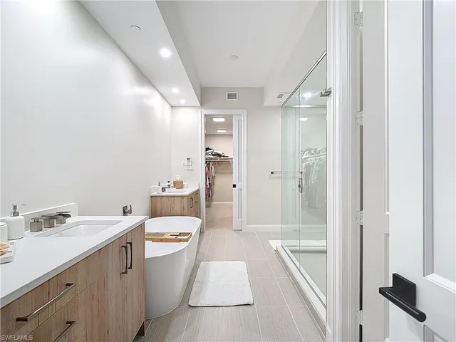 a bathroom with a sink a toilet a tub and shower