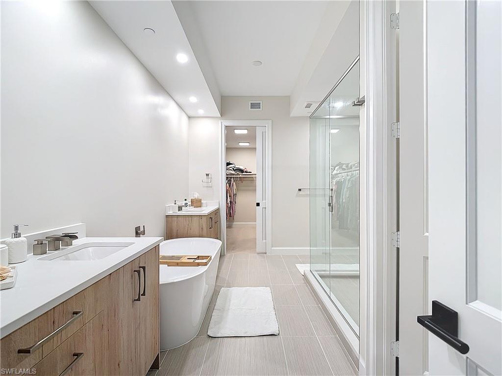 1125 Central Avenue, Unit 462 Naples, FL 34102 - Photo 19 of 48 a bathroom with a sink a toilet a tub and shower