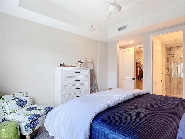 a bedroom with a bed and a mirror