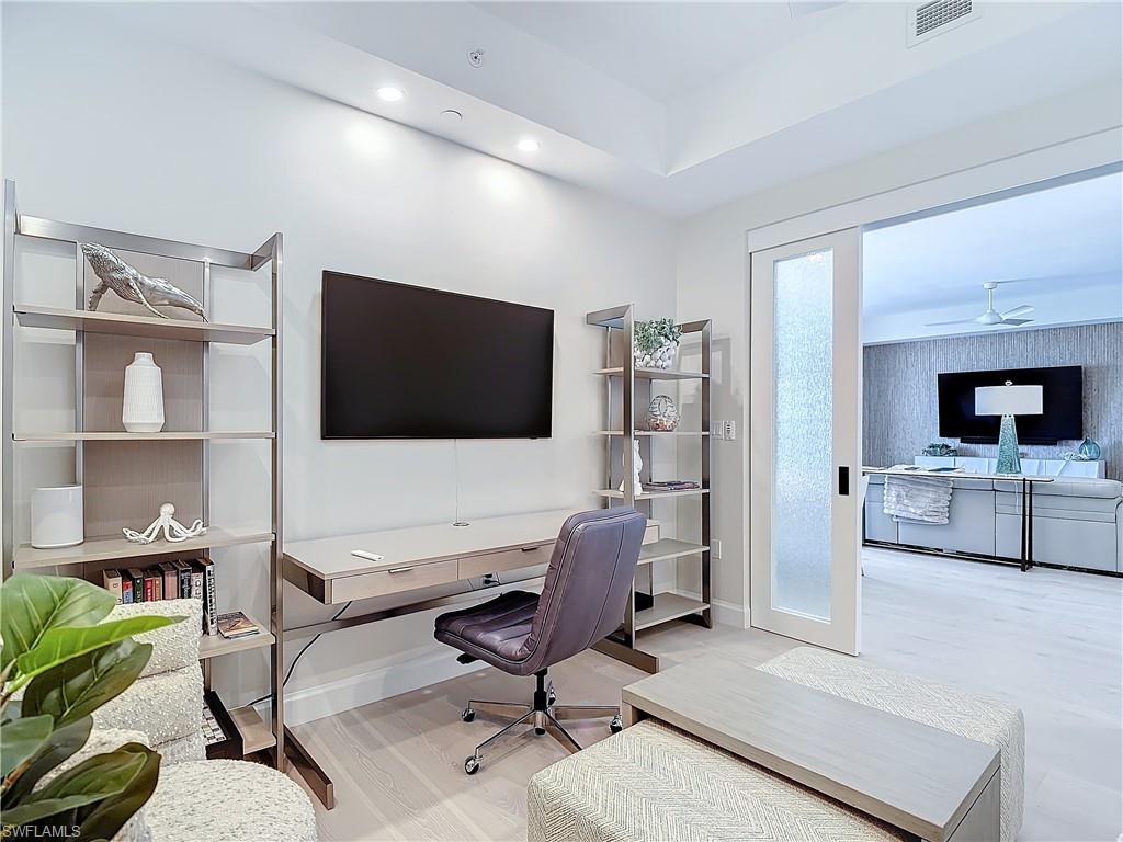 1125 Central Avenue, Unit 462 Naples, FL 34102 - Photo 26 of 48 a living room with furniture and a flat screen tv