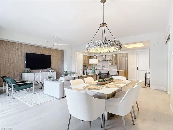a view of a dining room with furniture wooden floor and chandelier