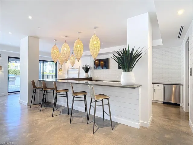 a large white kitchen with a large window