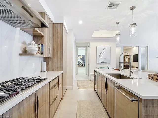 a kitchen with a sink stove and cabinets