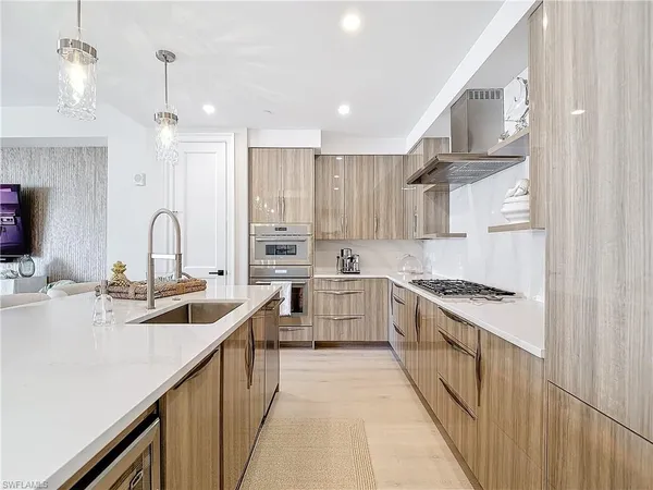 a kitchen with stainless steel appliances granite countertop a sink stove and cabinets